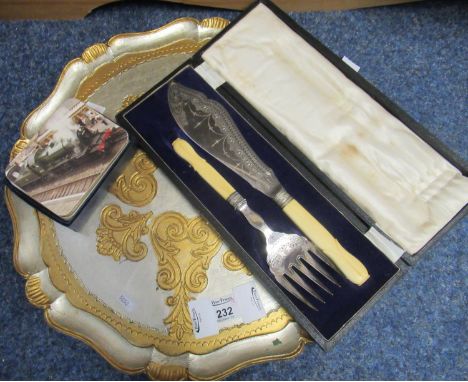 Cased silver plated fork and knife set, together with locomotive placemats, circular silver and gold finish tray and an empty