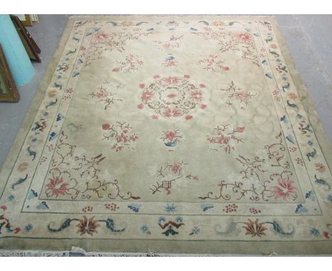 20th Century green and beige carpet of large proportions decorated with oriental style flowers and foliage. 320 x 357cm appro