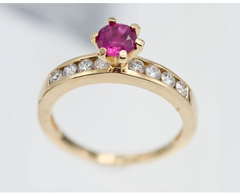 An 18ct yellow gold diamond and ruby ring, size L/M.