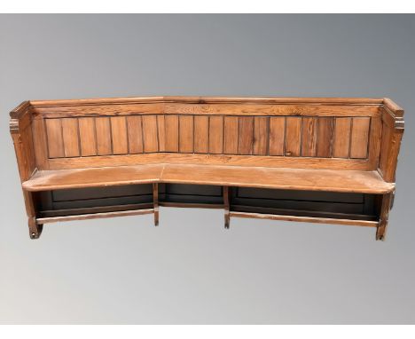 A Victorian pitch pine curved church pew, total length 230 cm.