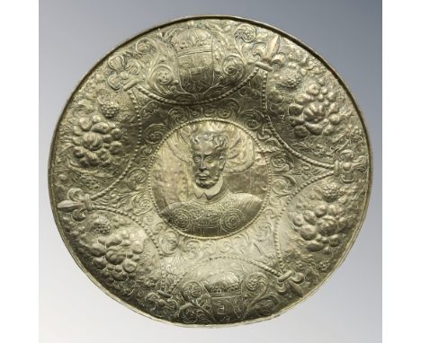 A large embossed brass charger, diameter 97 cm.