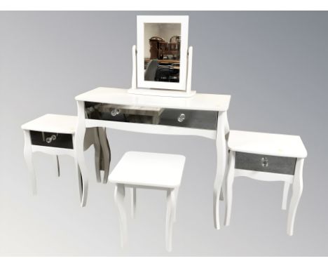 A modern white dressing table with mirror back and stool, and matching bedside stands 