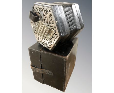 An early 20th century twenty four button concertina, with pierced chrome end pieces and black leather bellows, lacking makers