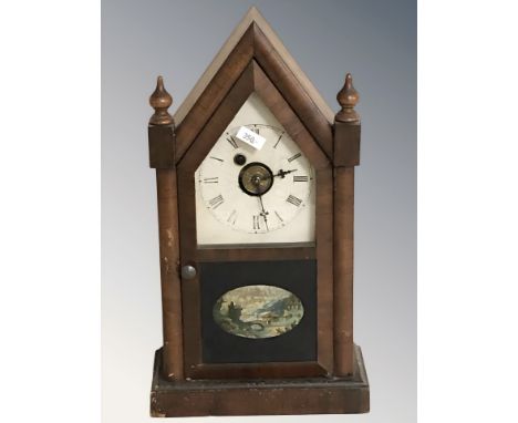 A 19th century American mantel clock by the Waterbury Clock Company, with pendulum and key, height 39 cm.