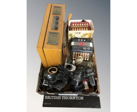 A vintage style record player, two miniature accordions, two Minolta cameras, Praktica camera, lenses, fishing reels, a table