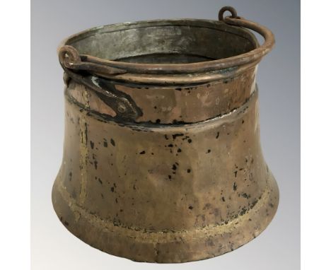A copper swing handled cooking pot, height 26 cm excluding handle.
