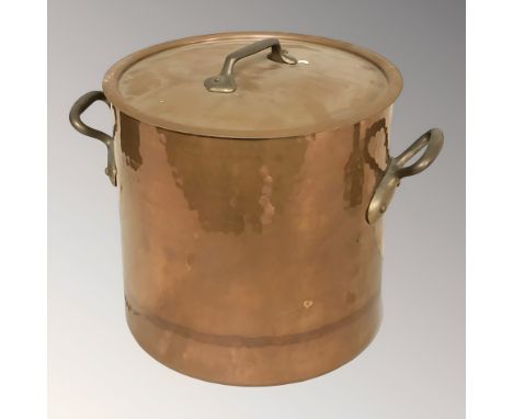 A copper and brass twin handled cooking pot, height 31 cm.