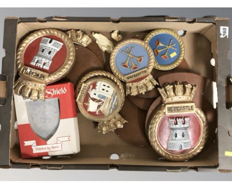 A group of ceramic Royal Navy warship  crests on wooden shields 