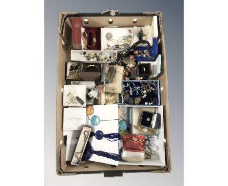 A box of mixed costume jewellery including earrings, pendants, cufflinks, wristwatches, pens, etc.