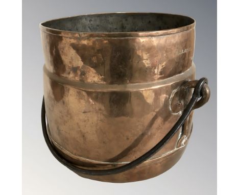 A copper swing handled cooking pot, height 23 cm excluding handle.
