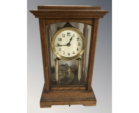An oak-cased four-glass Gustav Becker torsion mantel clock, with key, height 32 cm.