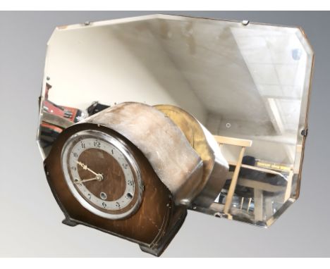 An Art Deco frameless mirror, width 58 cm, and a mantel clock. 