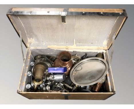 A vintage trunk containing a large quantity of metal wares including EPNS, brass and copper wares, candlesticks etc  