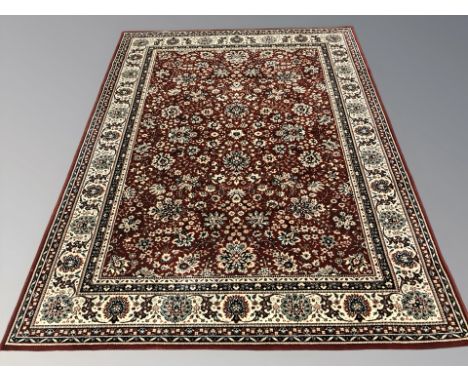 A machine made rug of Persian design, 240 cm x 172 cm