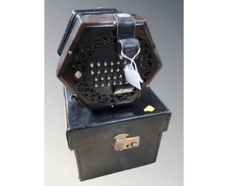 An early 20th century twenty four button concertina, with rosewood fret work end pieces and black leather bellows, numbered 3