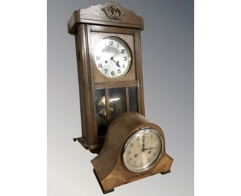 An early 20th century oak wall clock, with pendulum and key, length 63 cm, and a further mantel clock.