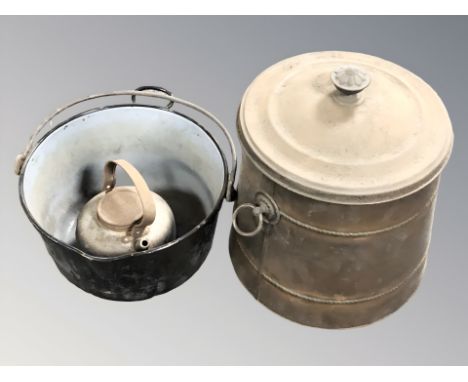 An enameled metal cooking pan, a kettle and a further lidded pot.