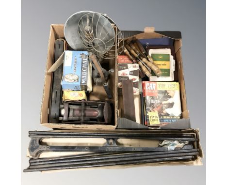 A group of vintage tools, blow lamp, hand drill, industrial enamelled light, wood working chisels, automobile related volumes