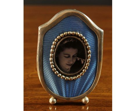 A Small Russian Silver Photograph Frame with blue guilloche enamel inset, a beaded inner edge to the oval picture aperture an