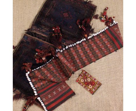 A Carpet Saddle Bag woven with a small rose quadriform medallion to the centre surrounded by dark inky blue scrolls in a band