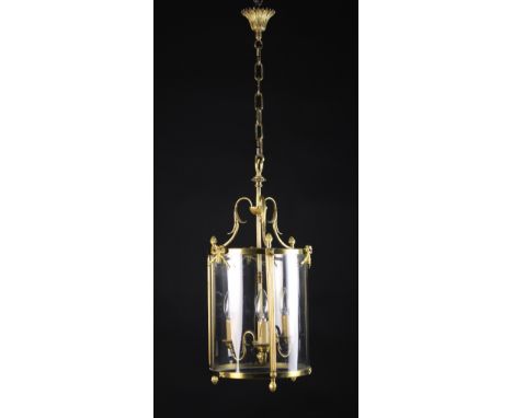 A Gilt Brass Hanging Lantern.  The three S-scroll candle branches emanating from a central reeded rod within a glazed cylindr