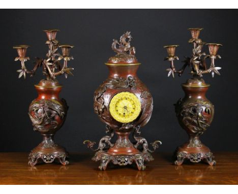 A 19th Century Bronzed Chinoiserie Clock Set.  The intricately cast gilt dial housed in a globular urn cast in relief with a 