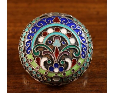 A Russian Enamelled Snuff Box with hinged lid and scrolling decoration, 1¾ ins (4.5 cms) in diameter.