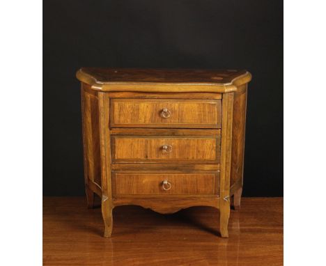 A Miniature Serpentine Front Chest of Drawers inlaid with stringing and having three drawers with ring handles flanked by can