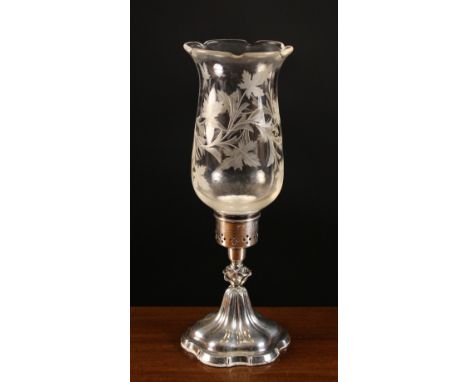 A Silver Candle Lamp having a cut glass shade decorated with undulating foliage and mounted on a flared serpentine edged pede