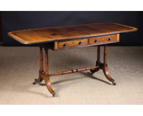A Fine Quality Rosewood Sofa Table.  The rectangular top with rounded drop flaps to each end on fly bracket supports, inlaid 