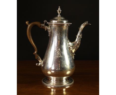 A George III Silver Coffee Pot hallmarked London 1775 with William Grundy maker's stamp. The baluster shaped pot engraved wit