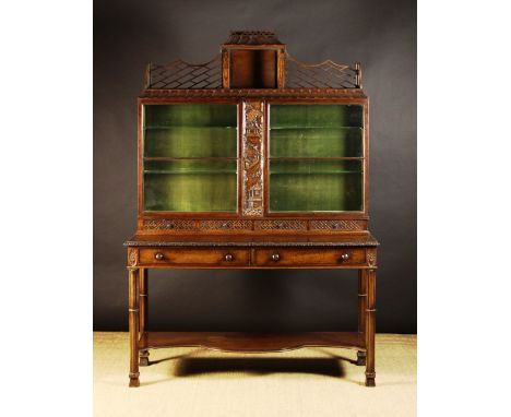 A 19th Century Two Part Carved Mahogany Display Cabinet in the Chinese Chippendale style. The upper section having two glazed