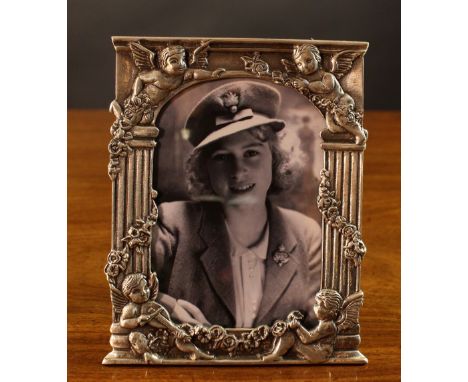 A Russian Photograph Frame with Kokoshnik mark & 84 stamp. The frame cast with winged cherubs bearing garlands of roses to th