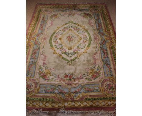 A Large Fine Quality English 'Aubusson' Style Carpet, woven with a bouquet of pink roses to the centre within garlands of flo