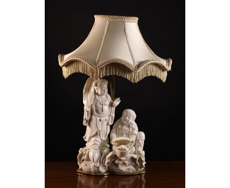 A Blanc-de-Chine Figure Group converted to a lamp. Modelled in the form of two Buddhistic figures; one stood on a lotus flowe