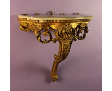 A Small Louis XV Gilt Console (A/F).  The white marble serpentine top with moulded edge supported on a carved and gesso-worke