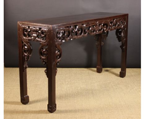 A Tall 19th Century Chinese Carved Altar Table.  The long rectangular top raised above a pierced apron of carved zoomorphic s