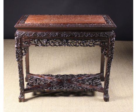 A Fine Chinese Carved Hardwood Table. The rectangular top having a brêche rouge marble centre panel framed in a carved border