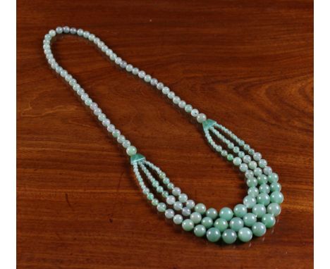 A Jade Necklace with three strings of beads. 