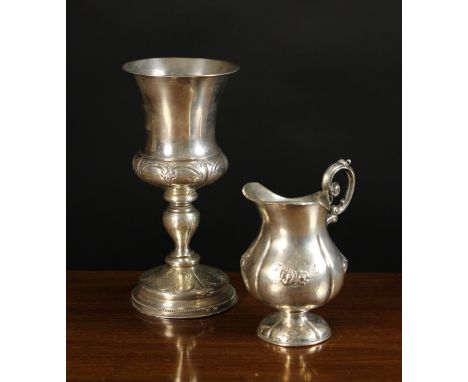 A 19th Century Russian Silver Goblet and Jug. The jug with lobed sides embossed and chased with sprays of flowers standing on