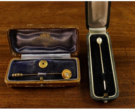 Two Cased Tie Pins: One of 15 carat gold set with a diamond and having a stamped 9 carat gold stud back fitted in a Reid & So