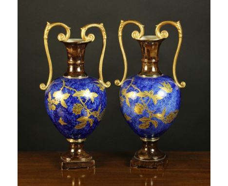 A Pair of Victorian Twin-handled Garniture Urns. The ovoid bodies stippled with a rich blue glaze and adorned with gilded bou