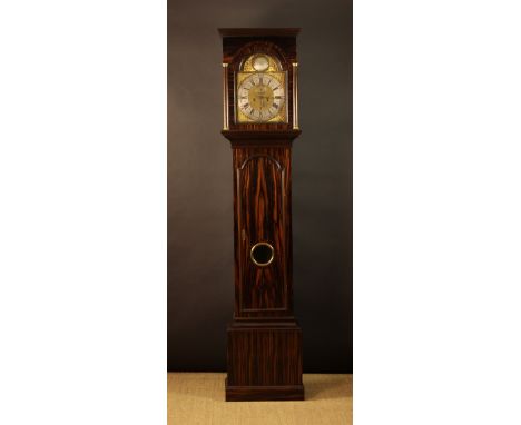 An 18th Century Eight Day Longcase Clock.  The case clad in striking stripped coramandel veneers. The 11¾ inch (30 cm)  brass