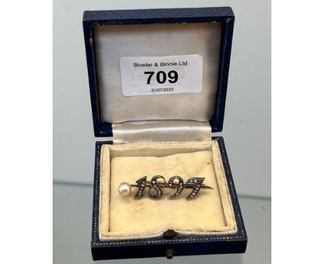 18ct white gold and diamond Queen Victorian 1897 Jubilee brooch set with a single large pearl. [3.61grams] 