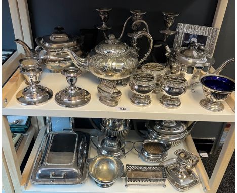Two Shelves of Silver plated and E.P Wares; candelabra, tea and coffee pots, photo frames, lidded tureens and a pair of dwarf