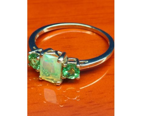 10ct yellow gold ladies ring set with Ethiopian opal stone off set by two green gem stones. [Ring size P] [1.96Grams] 