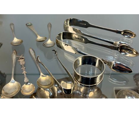 A Collection of silver flatwares and napkin ring; Georgian and Victorian sugar tongs, small Sheffield silver sugar tongs and 