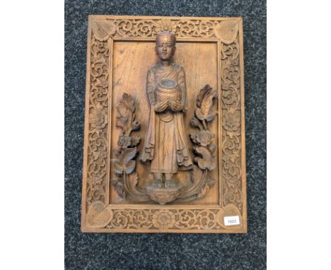Antique Chinese wooden hand carved raised relief figural panel. Depicts figure holding a pot standing on a podium, foliage sw