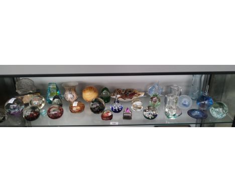 A large shelf of glass paperweight to include Caithness and Selkirk Glass 