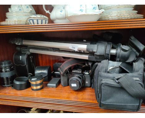 A Shelf of camera items to include Pentax camera and accessories 